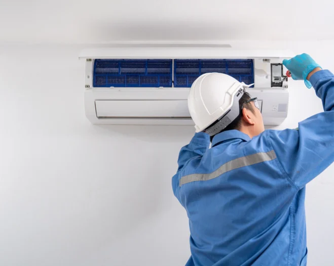 worker repairing an air conditioner